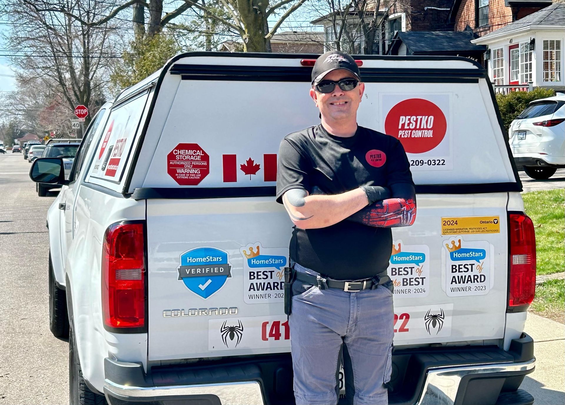 A man is standing in front of a white truck.