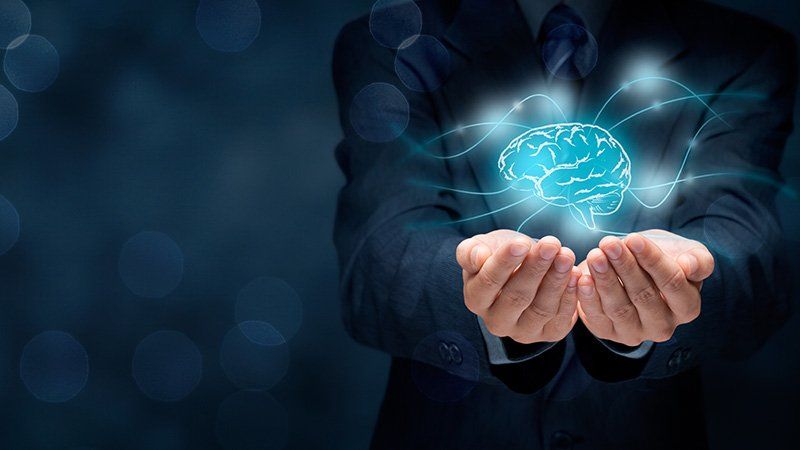 person holding an image of a brain