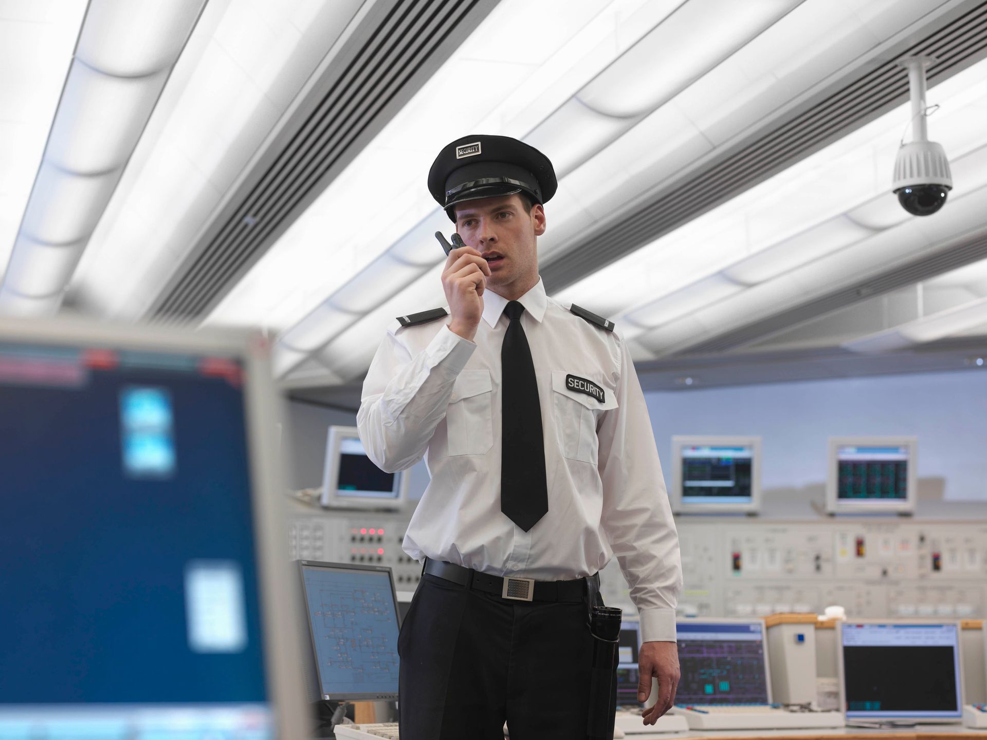 Security officer speaking on the radio, ensuring real-time updates and safety.