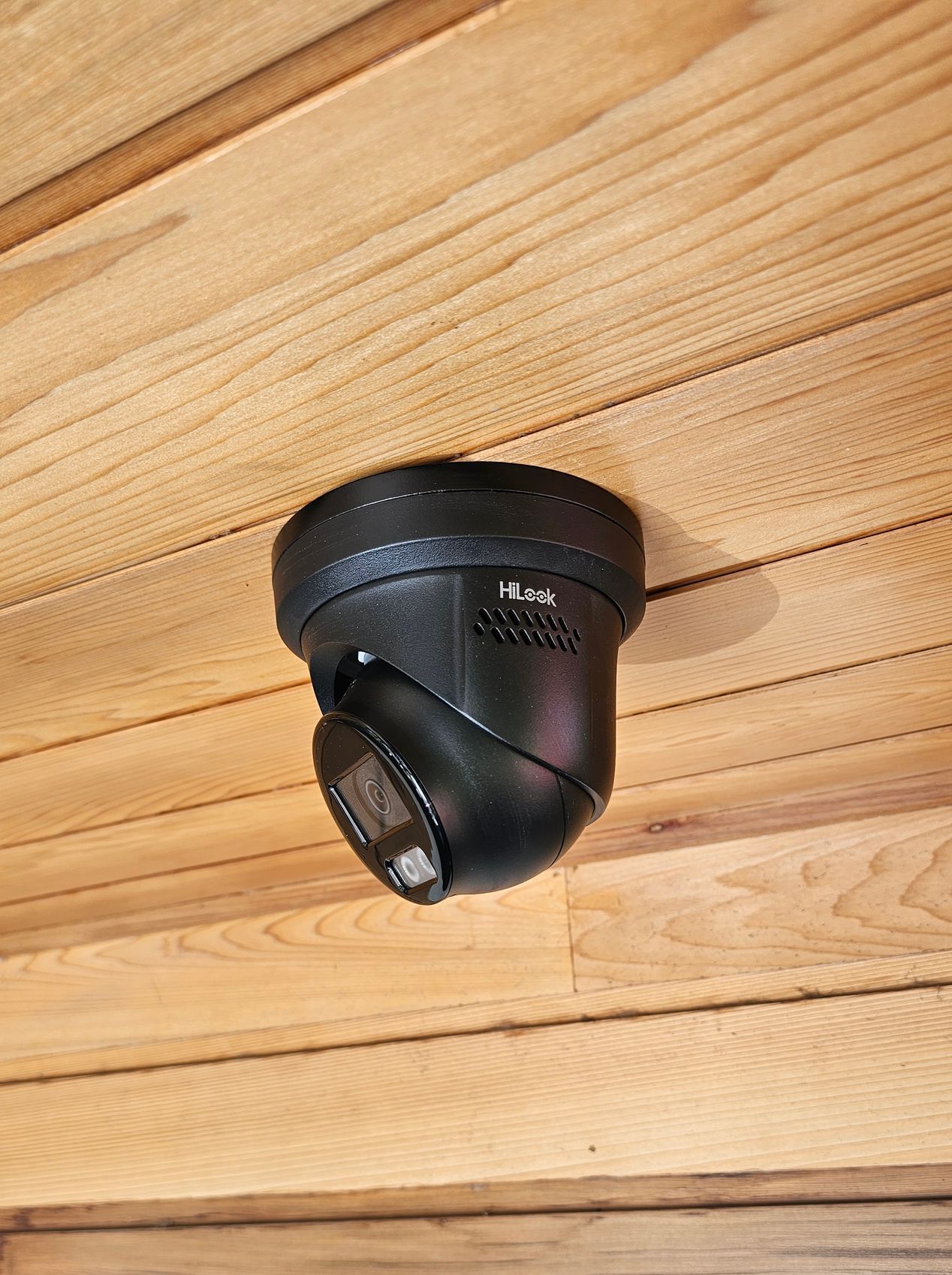 A security camera is mounted on the side of a building.