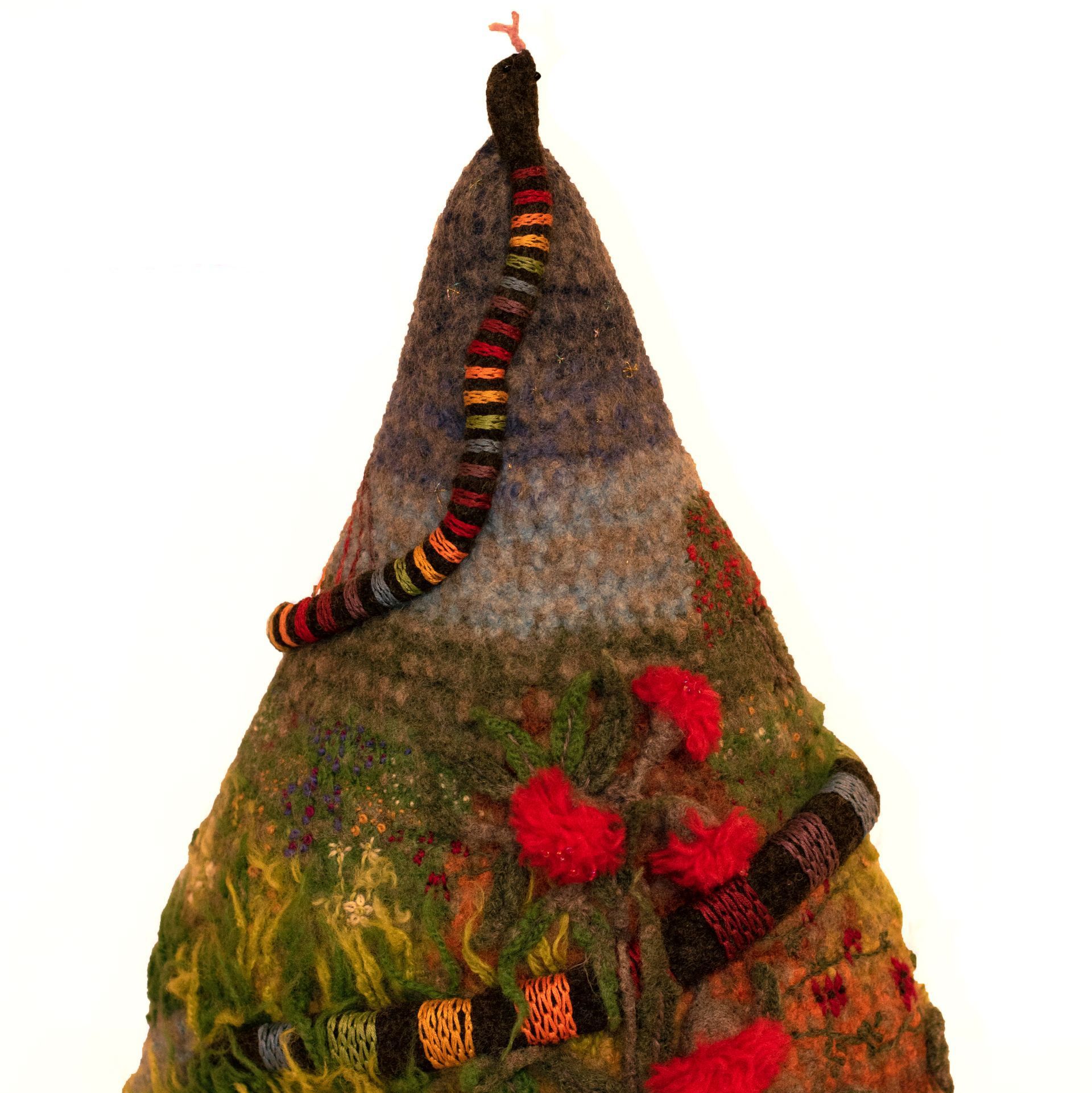 A knitted item with a snake on top of it