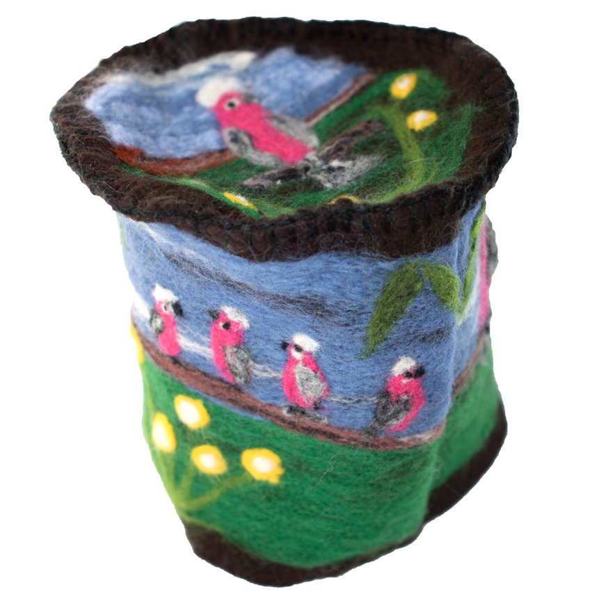 A bucket with birds and flowers on it