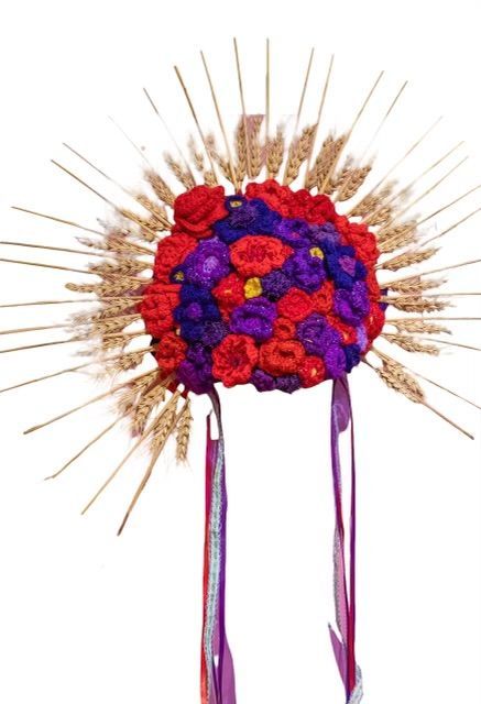 A crown made of flowers and wheat on a white background.
