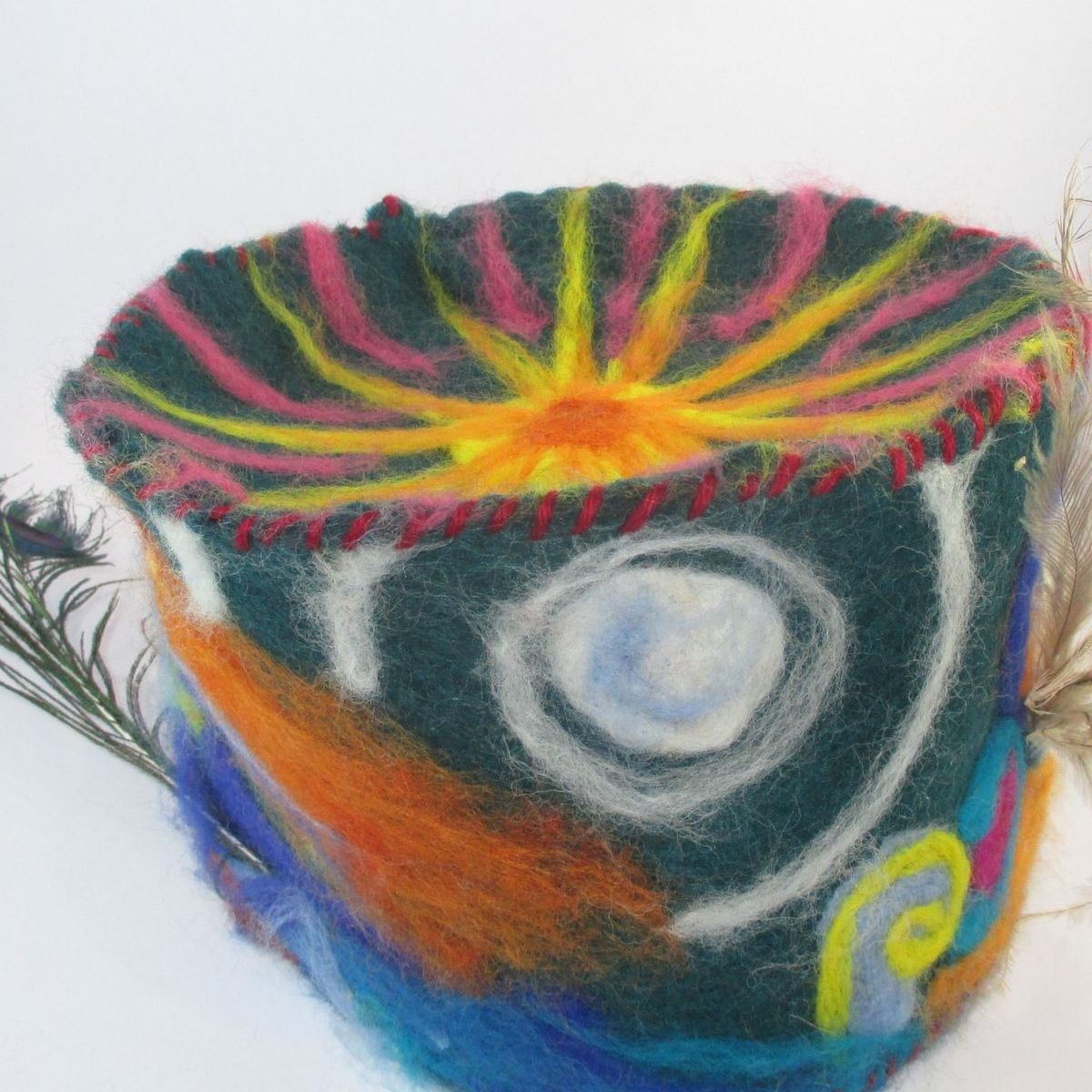 A colorful bowl with a peacock feather on it