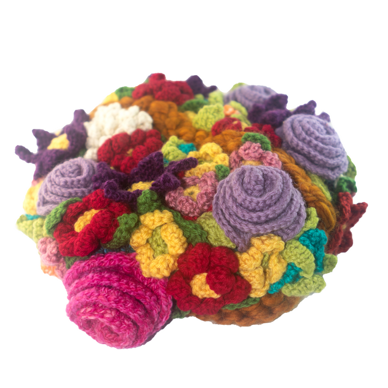 A bunch of colorful crocheted flowers on a white background