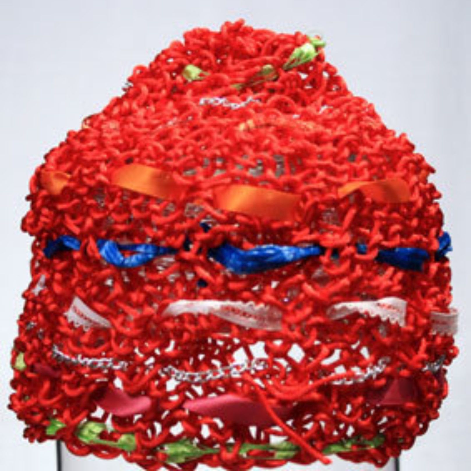 A red hat with ribbons and flowers on it