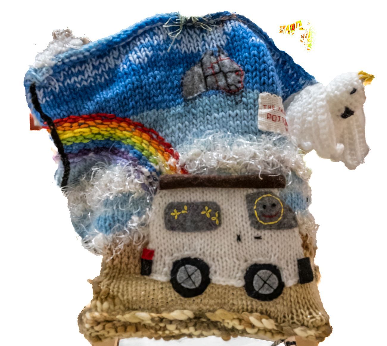 A knitted hat with a van and a rainbow on it