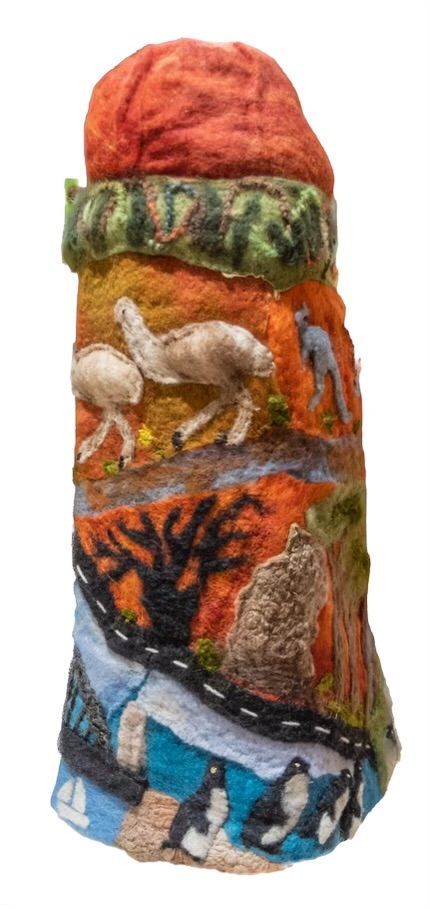 A sculpture of a landscape with animals and trees on a white background.