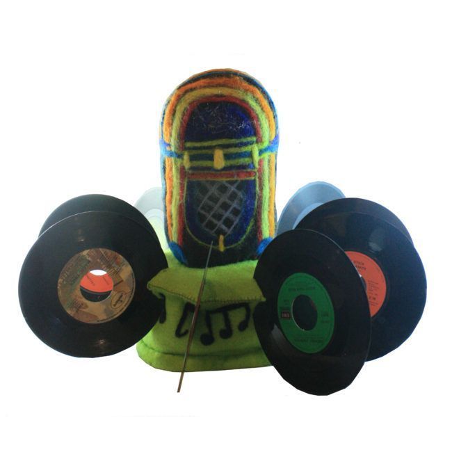 A jukebox with a bunch of records around it