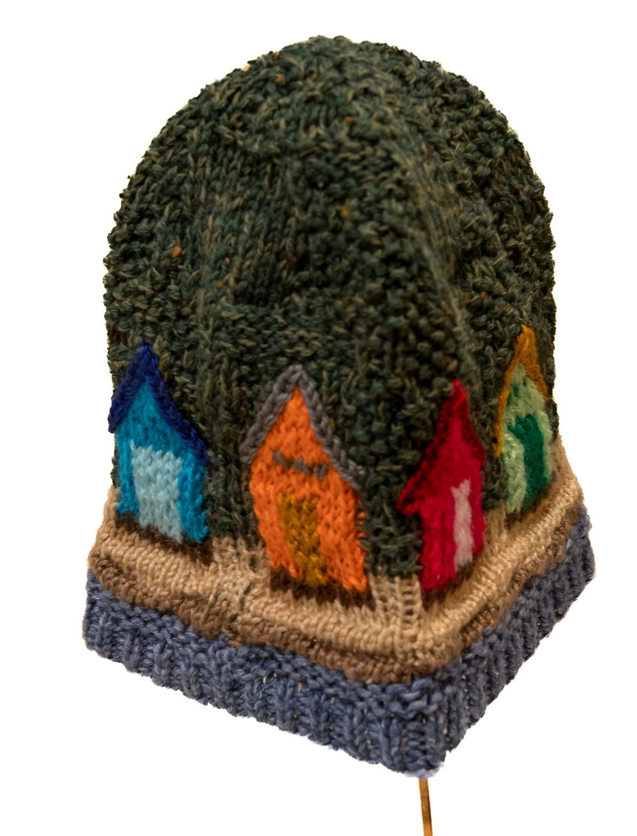 A knitted hat with houses on top of it