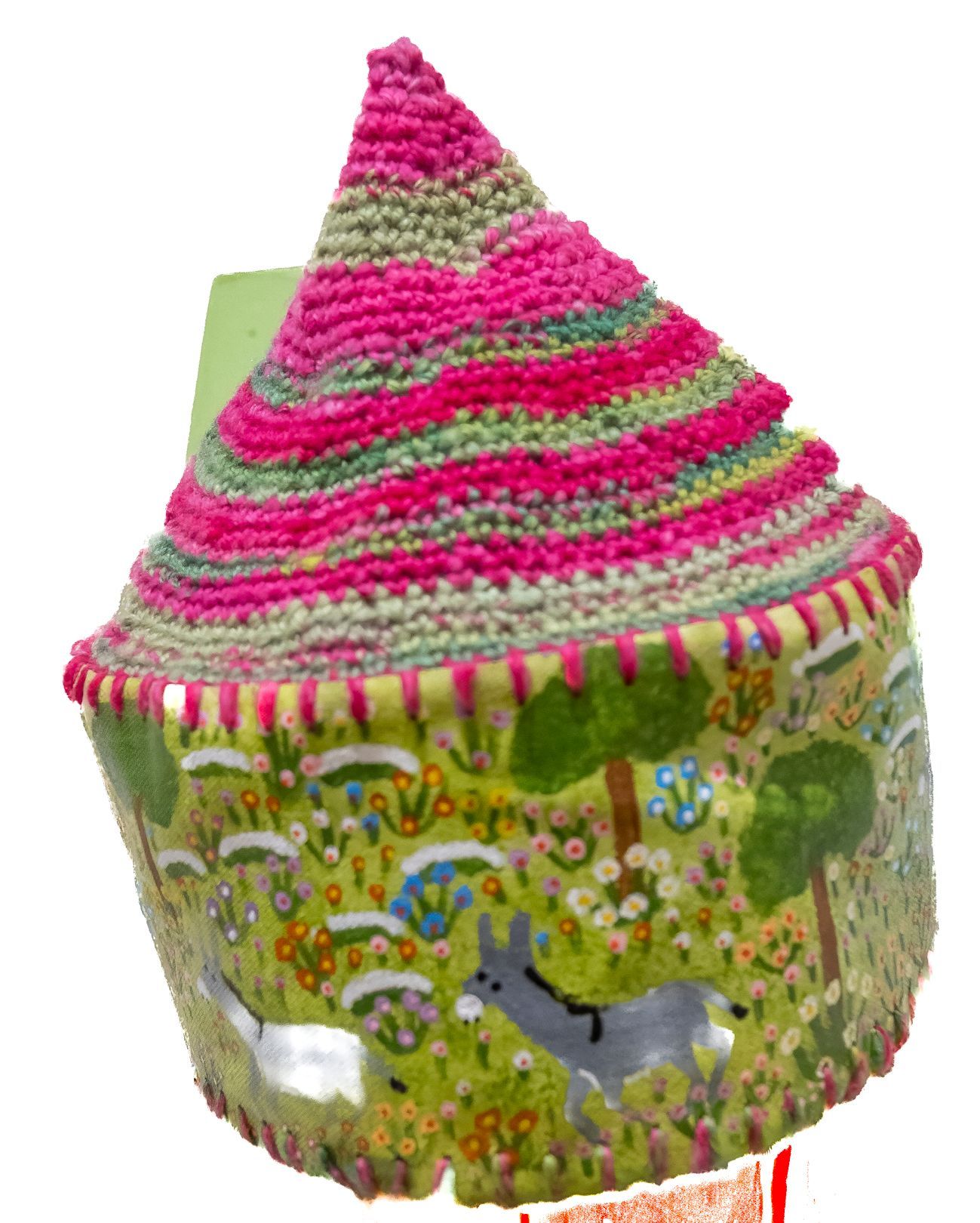 A colorful crocheted hat with trees and flowers on it