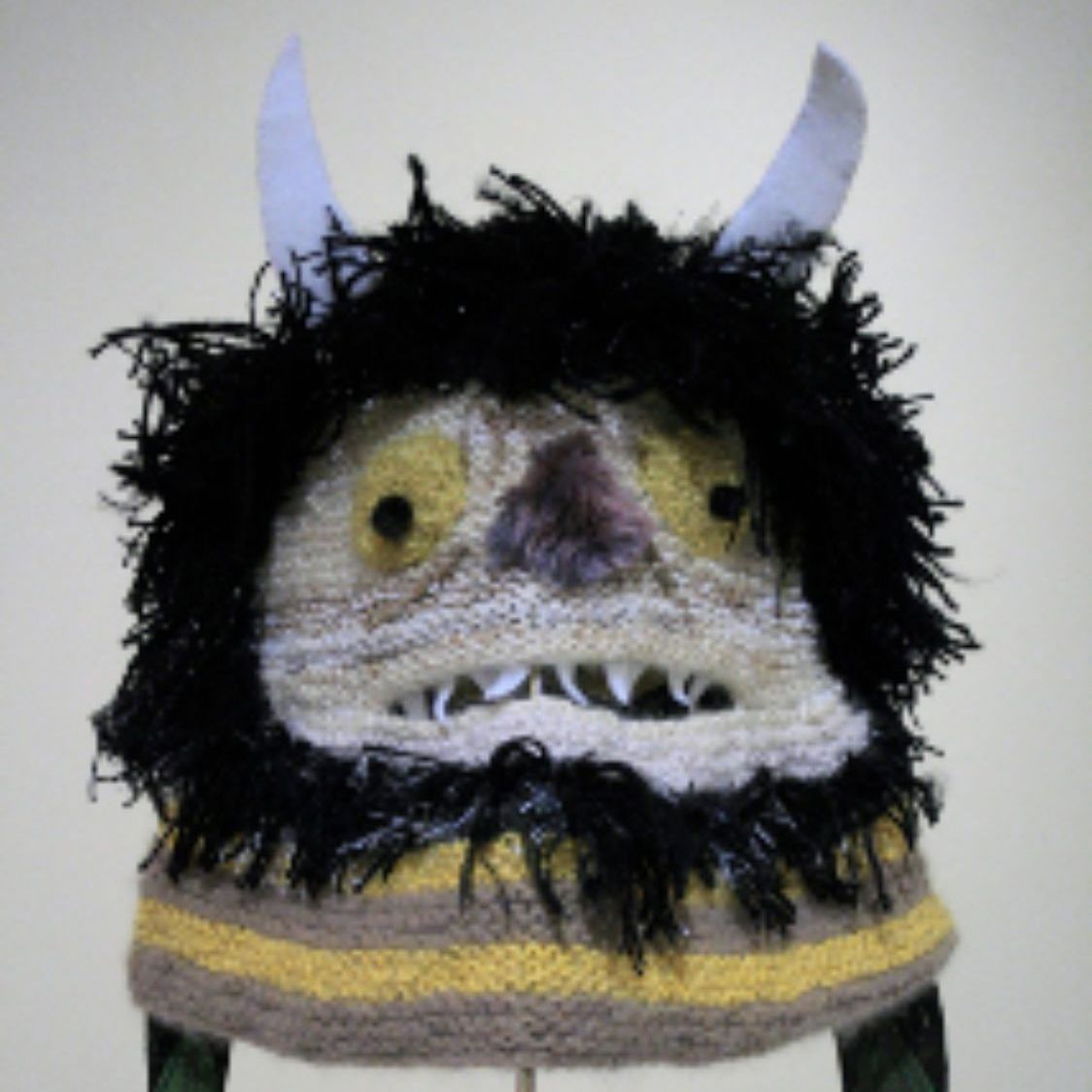 A knitted hat that looks like a monster with horns