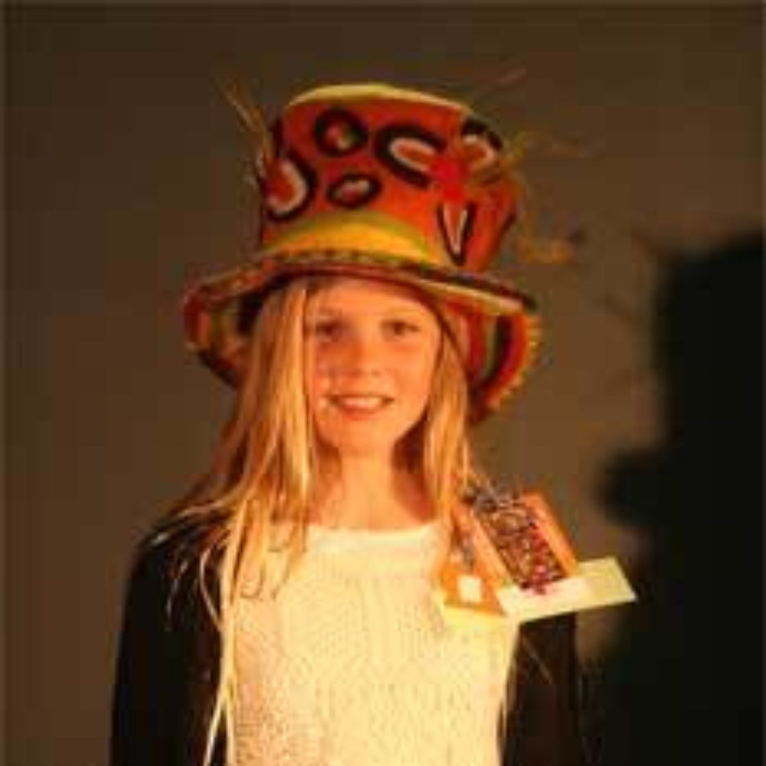 A young girl wearing a colorful top hat