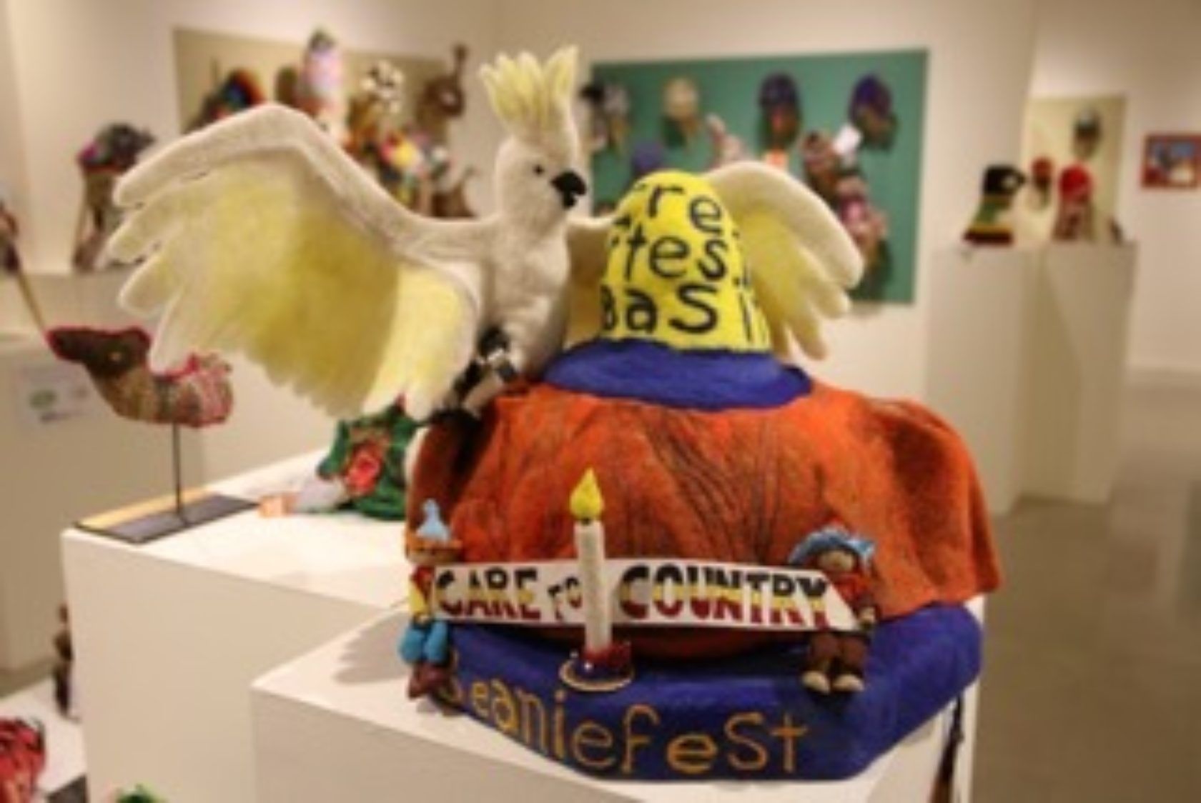A sculpture of a bird sitting on top of a cake that says jeaniefest