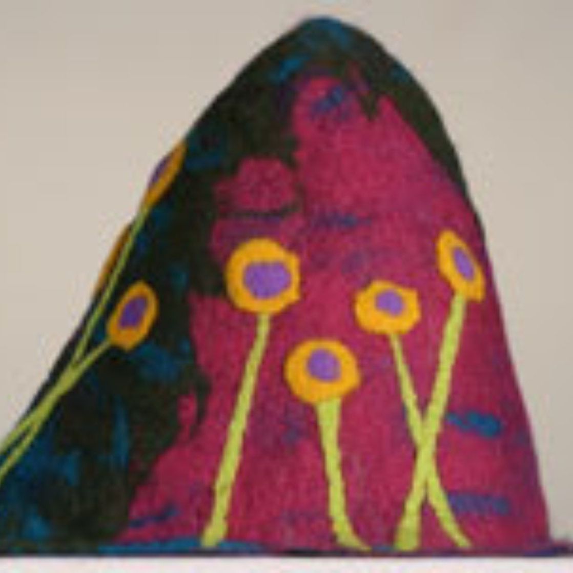A colorful hat with purple and yellow flowers on it