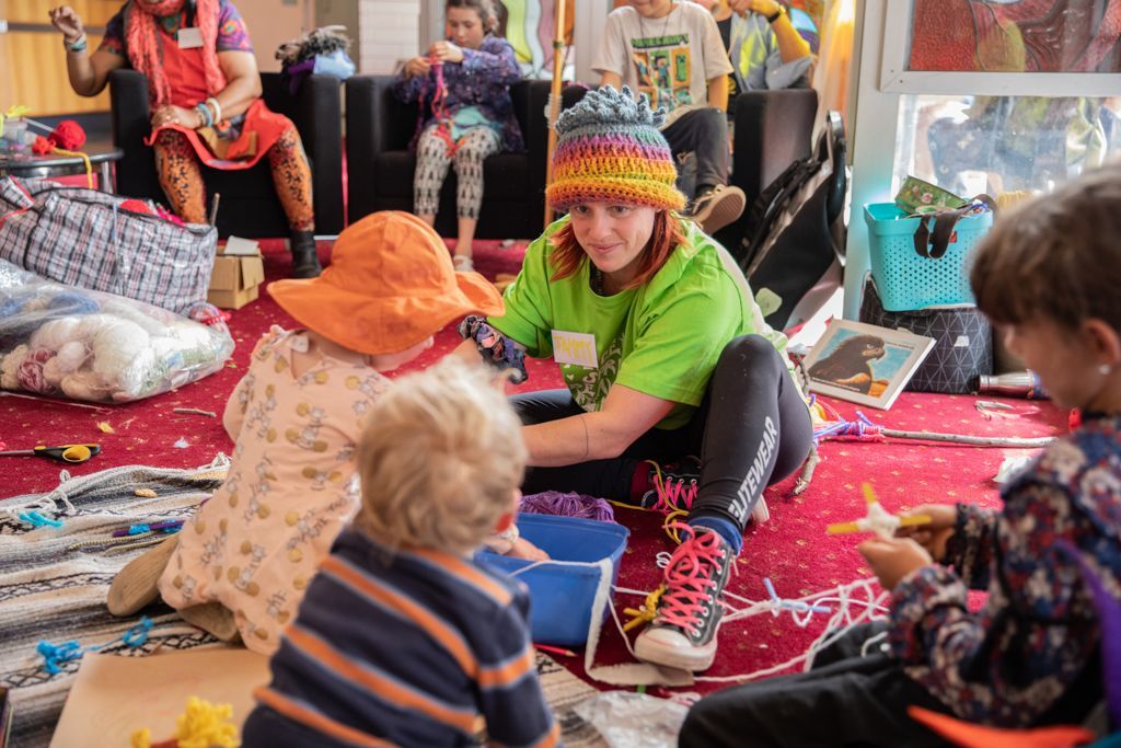 A group of children are playing with toys on the floor.