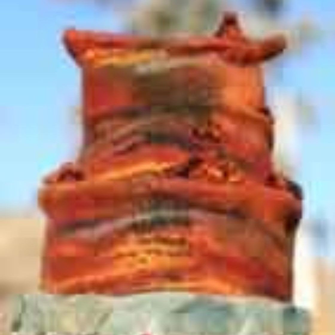 A close up of a stack of orange bags on top of each other.