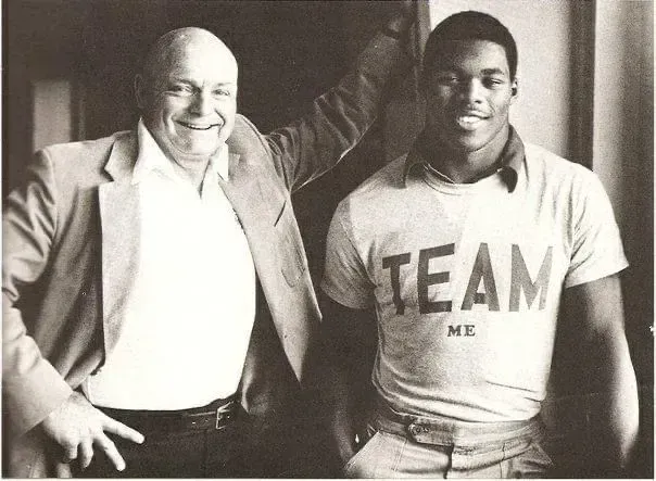 Man in blazer and smiling man wearing 