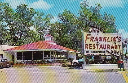 Day Franklin's Restaurant, a roadside diner, with a red roof, a large sign, and a vintage car.