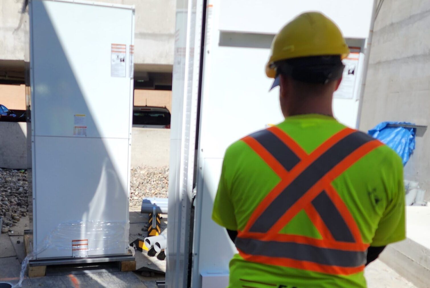 A construction worker wearing a yellow hard hat and safety vest