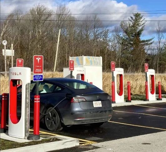A car is charging at a tesla charging station