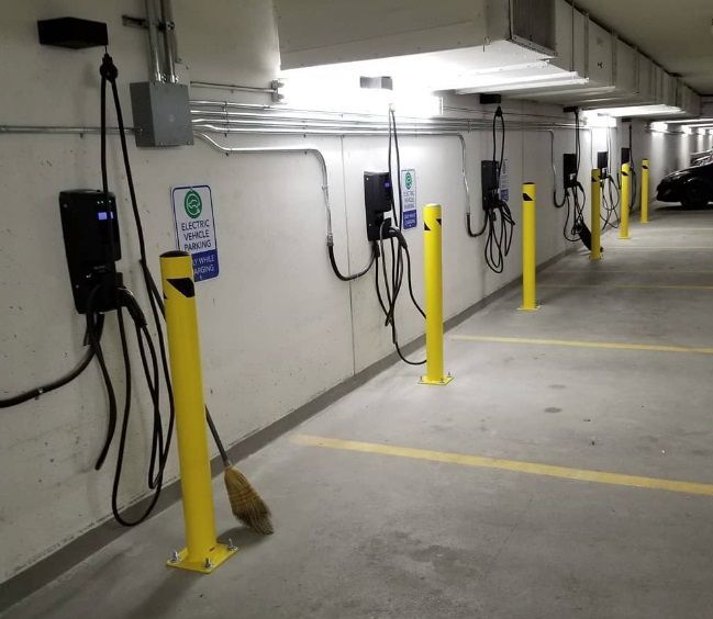 A row of charging stations in a parking garage