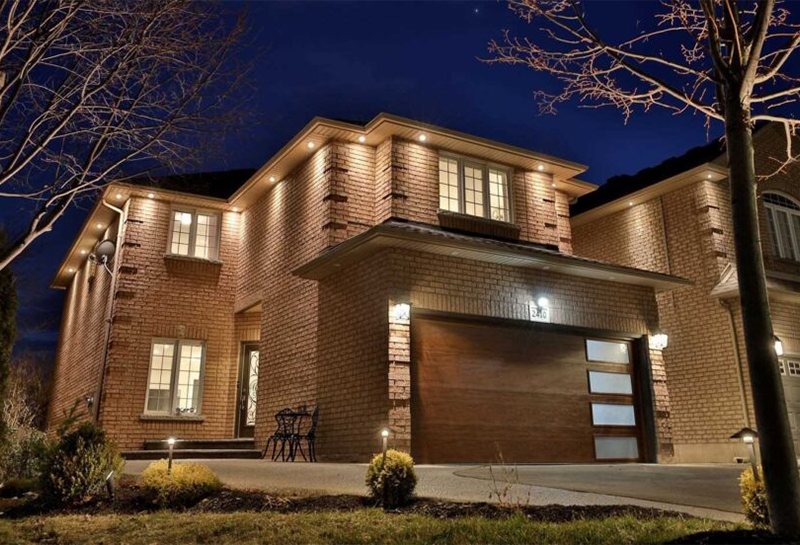 A large brick house is lit up at night