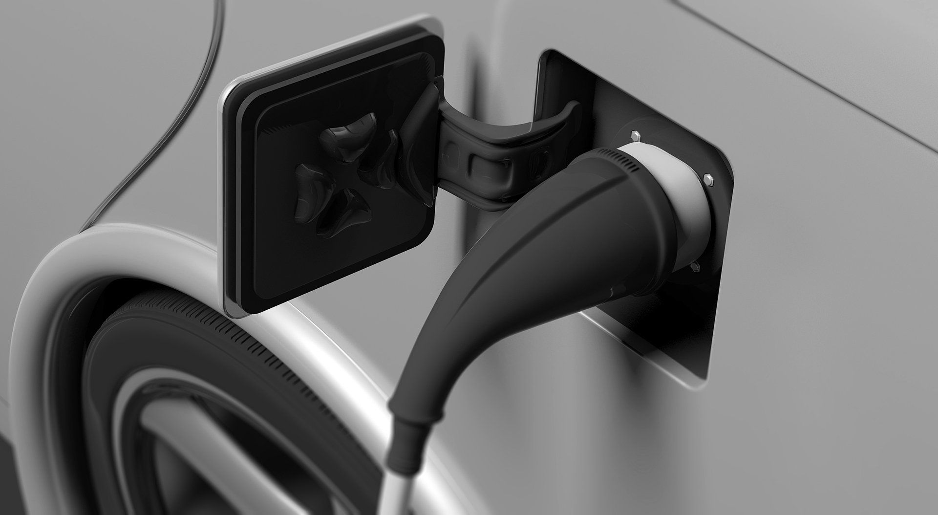 A black and white photo of an electric car being charged.
