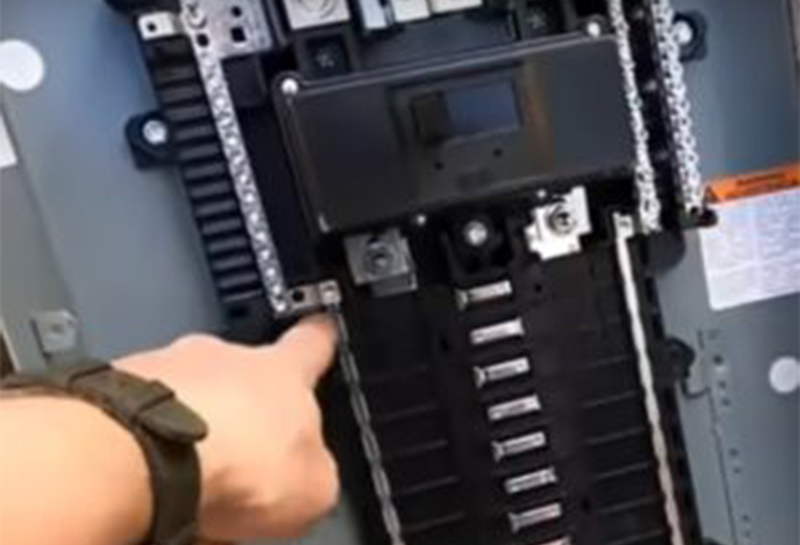 A person is working on a electrical panel.