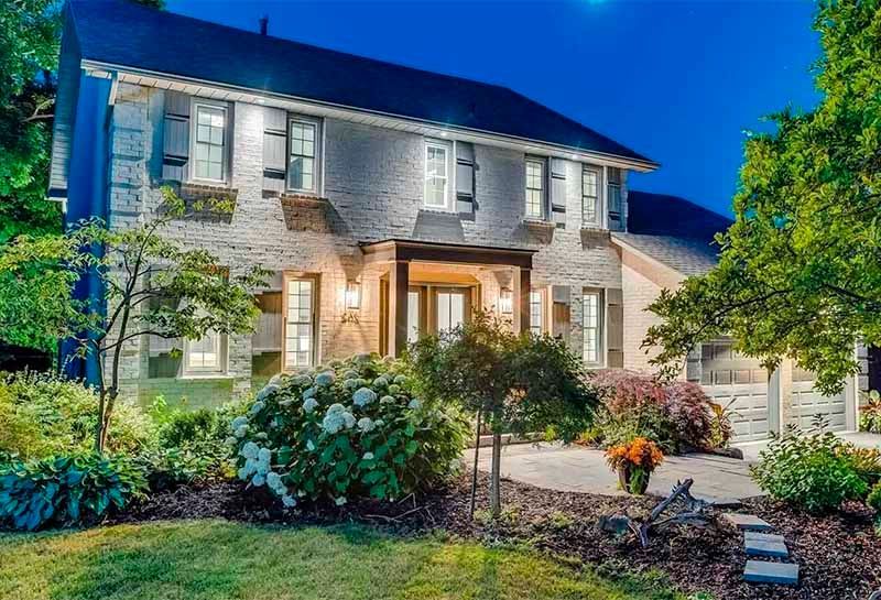 A large house with a lot of windows is lit up at night