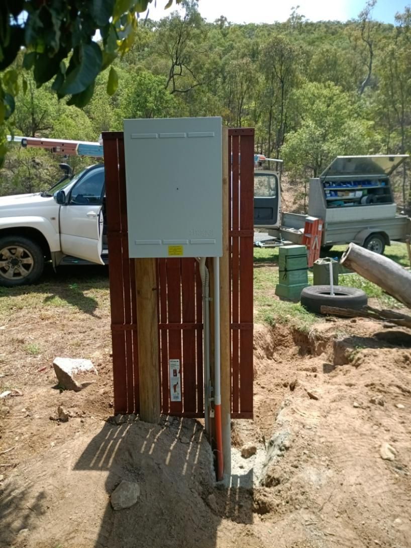 An Electrical Box On A Wooden Fence— Instant Spark Electrical in Glen Isla, QLD