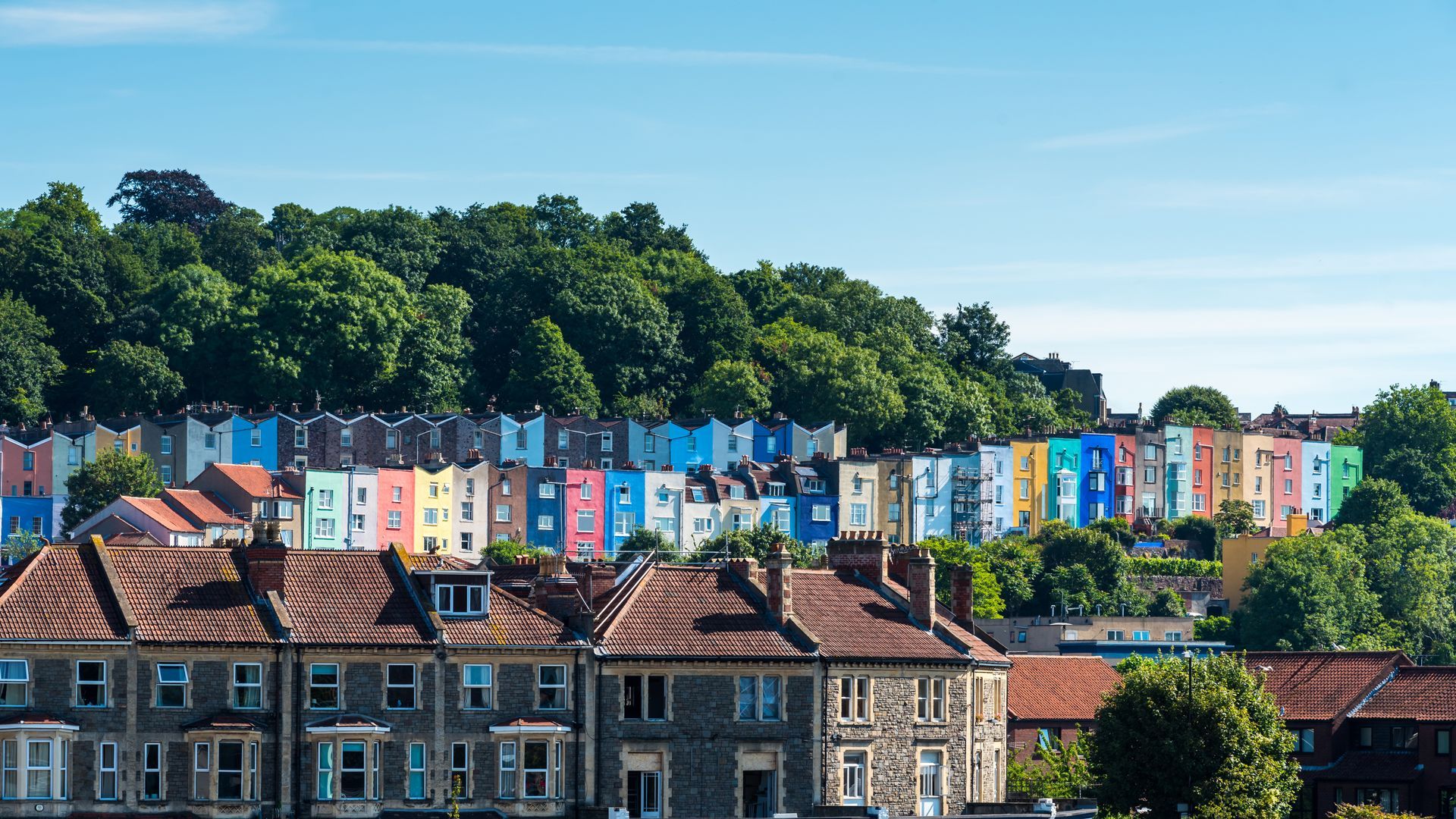 A row of colorful houses sitting on top of a hill.