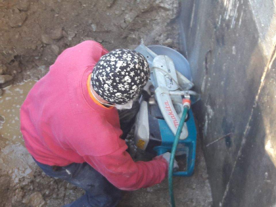 Worker Cutting Concrete