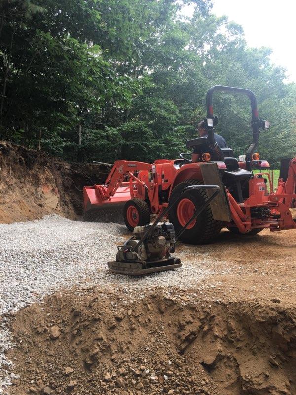 Professional Worker Pouring Gravel Using a Loader