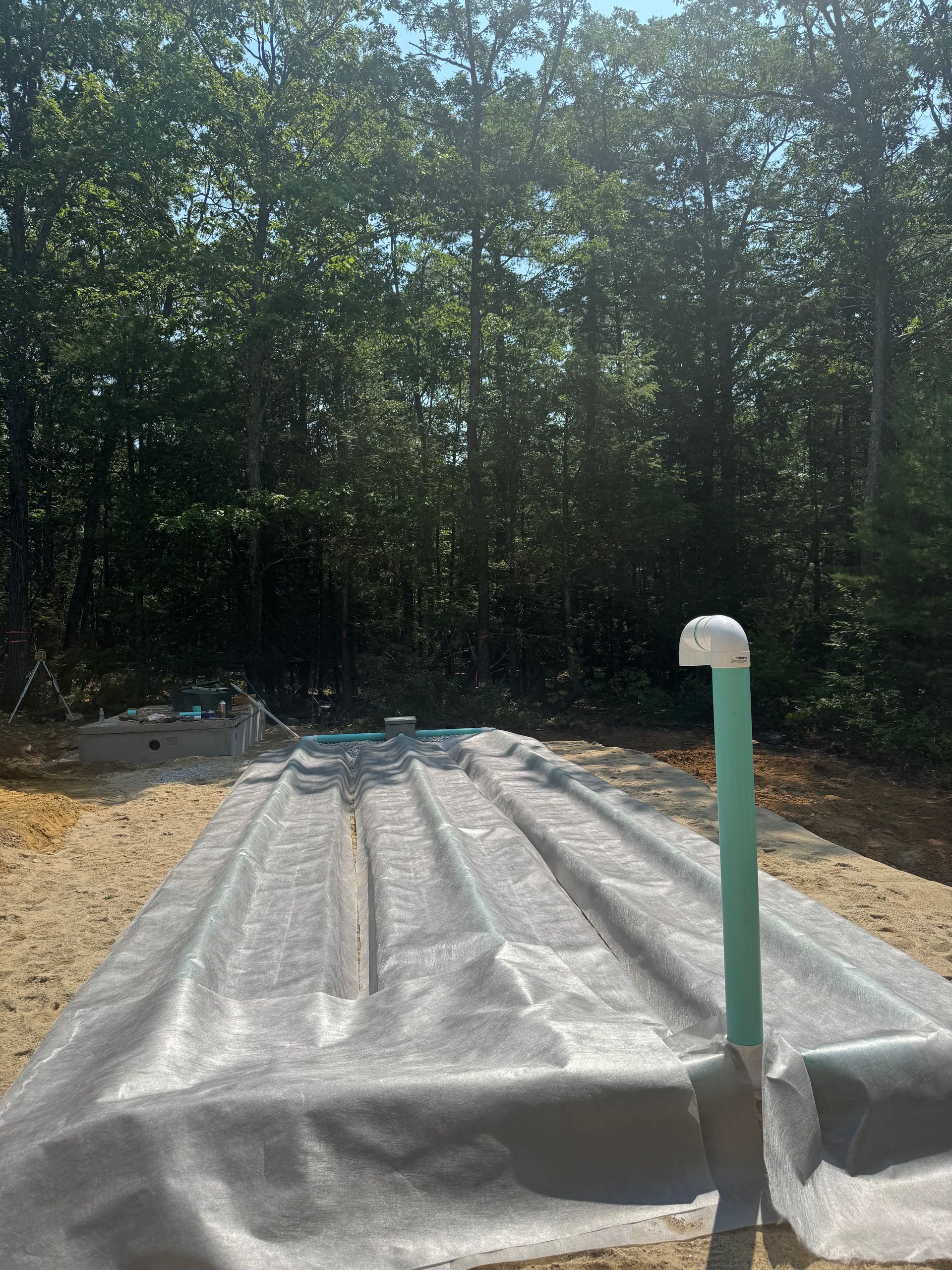 A septic tank is being built in the middle of a forest.