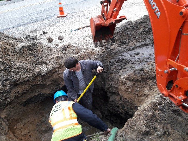 Professional Workers Doing Curb Box Excavation