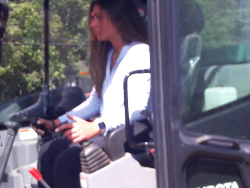 Woman operating A Backhoe