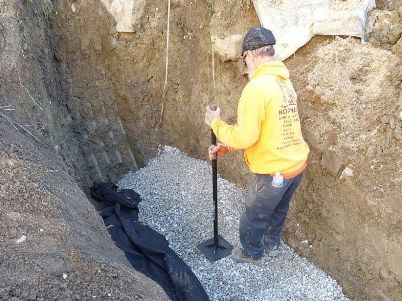 Professional Worker Doing Hand Tamping for Sewer Line