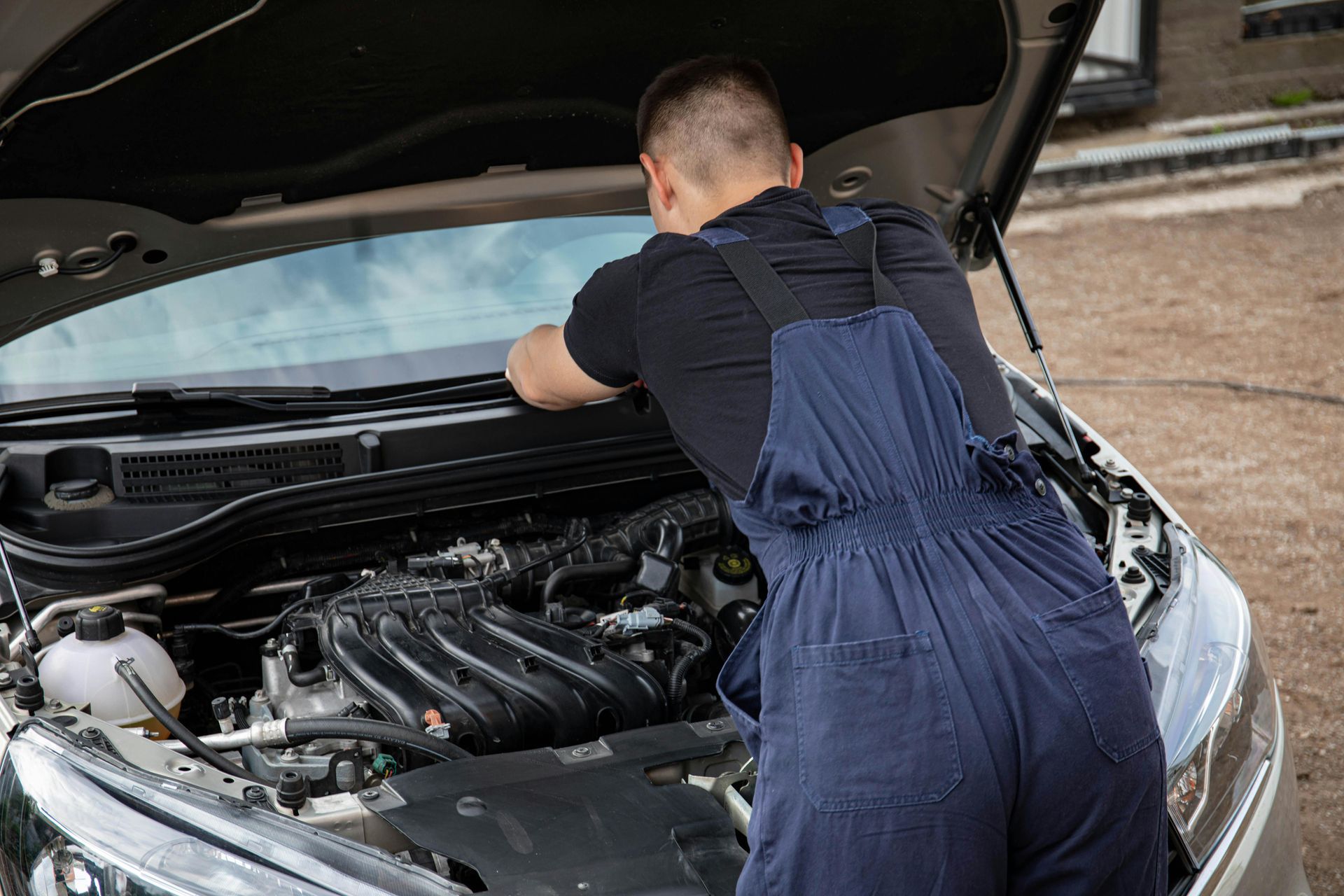 technician inspecting car air conditioning system at AutoWits Scottsdale auto repair shop