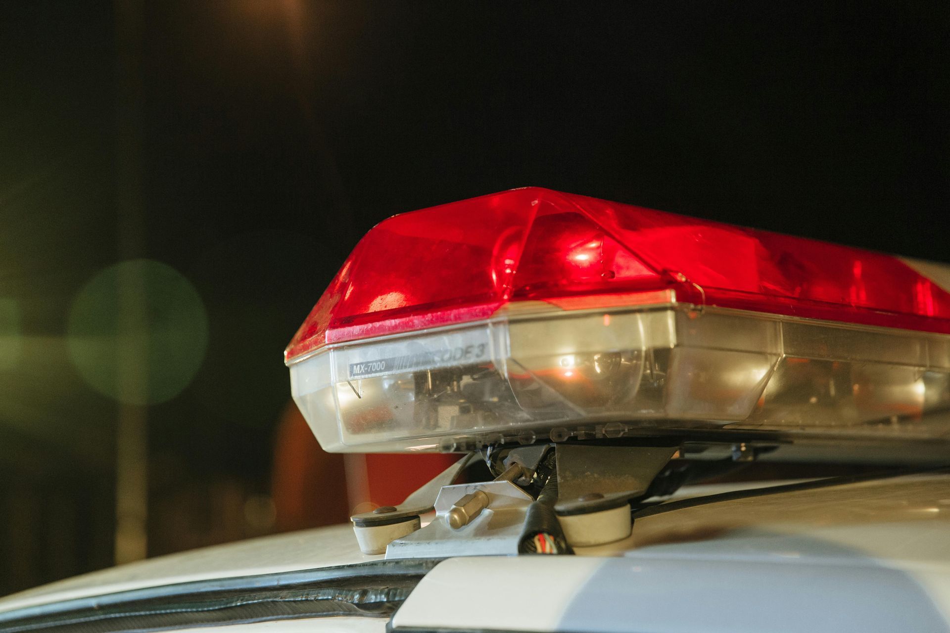 A close up of a red light on top of a police car.