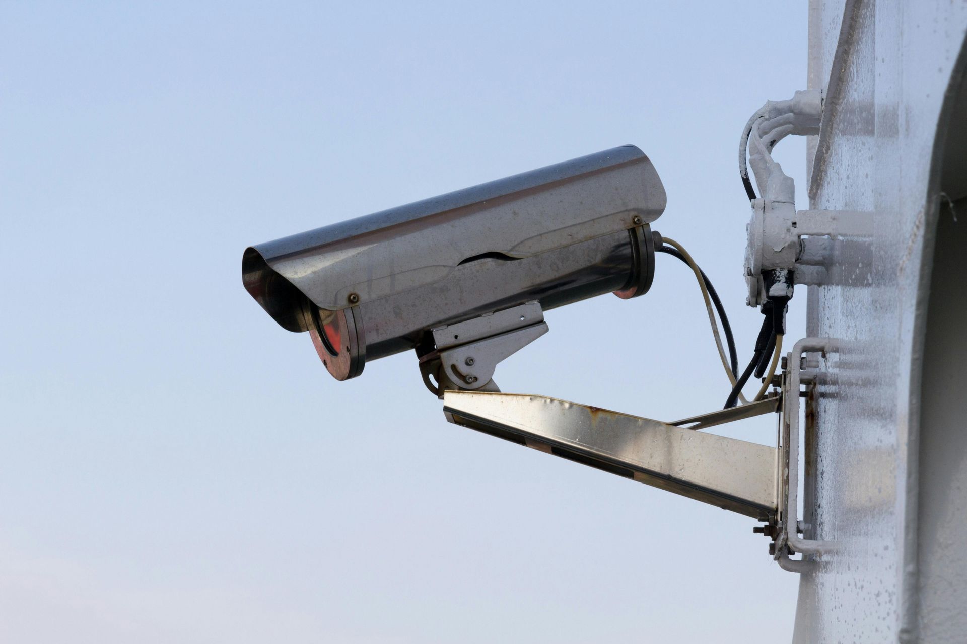 A security camera is mounted on the side of a building.