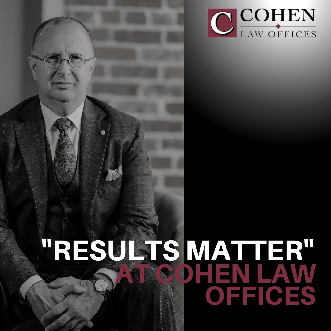 A man in a suit and tie is sitting in front of a cohen law office A man in a suit and tie is sitting in front of a cohen law office