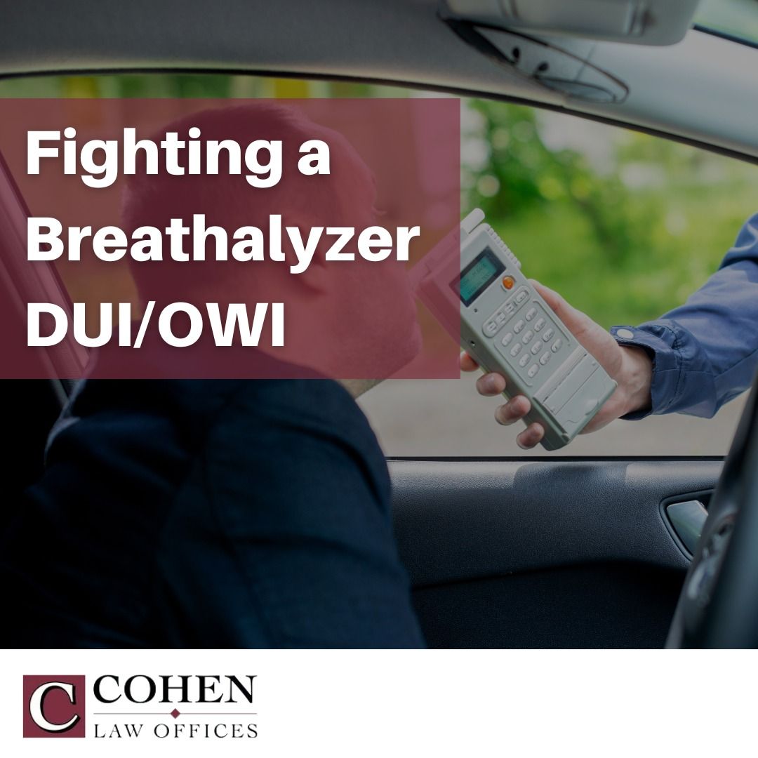 A man in a car is holding a breathalyzer in his hand A man in a car is holding a breathalyzer in his hand