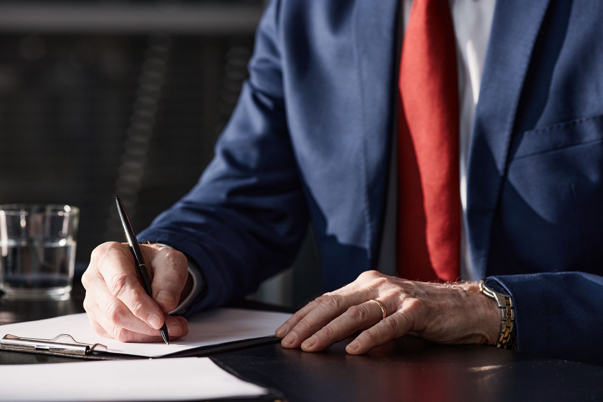 Close-up of a professional DWI lawyer signing paperwork to protect a client's legal rights. Close-up of a professional DWI lawyer signing paperwork to protect a client's legal rights.