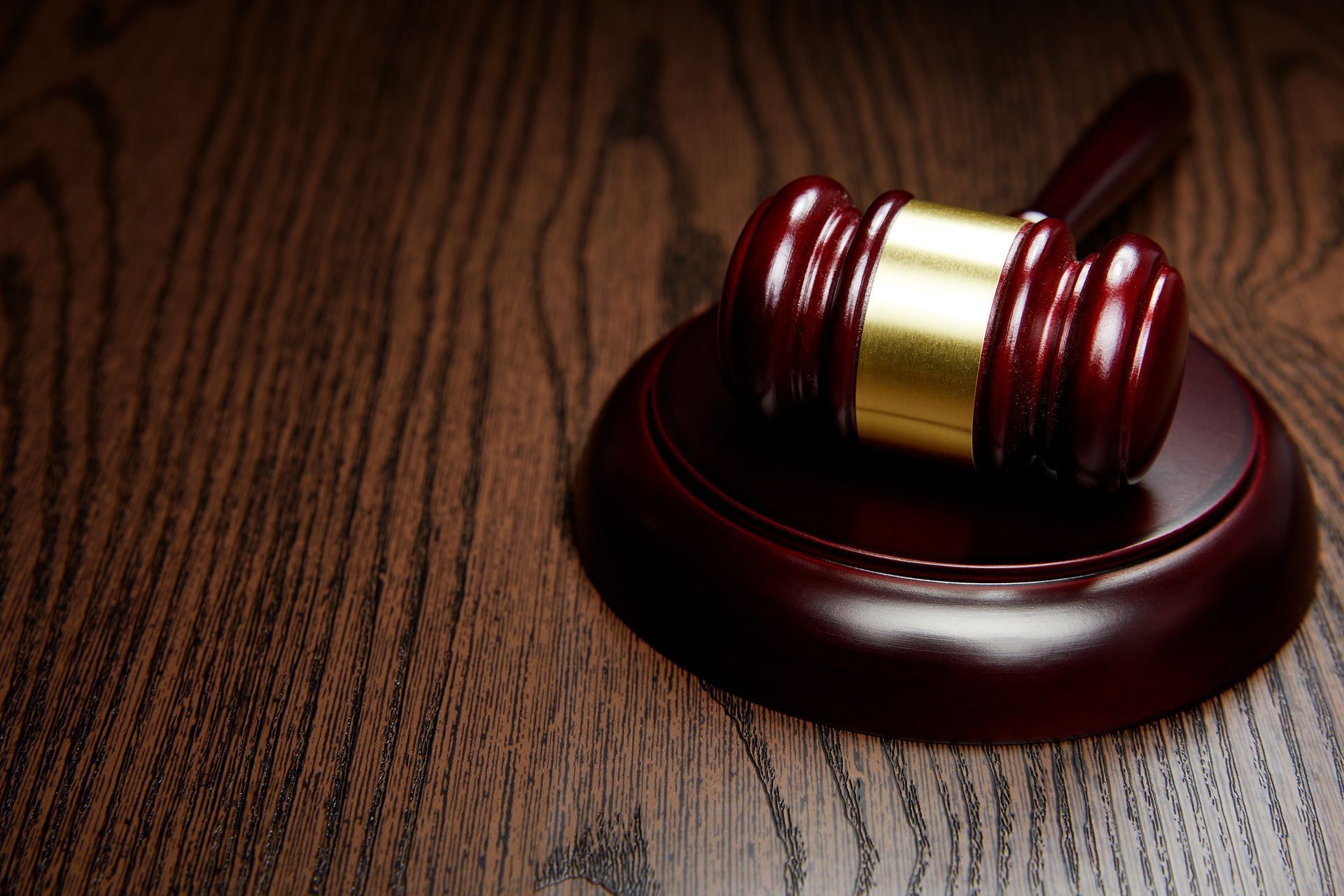 A wooden gavel on top of a wooden table. A wooden gavel on top of a wooden table.