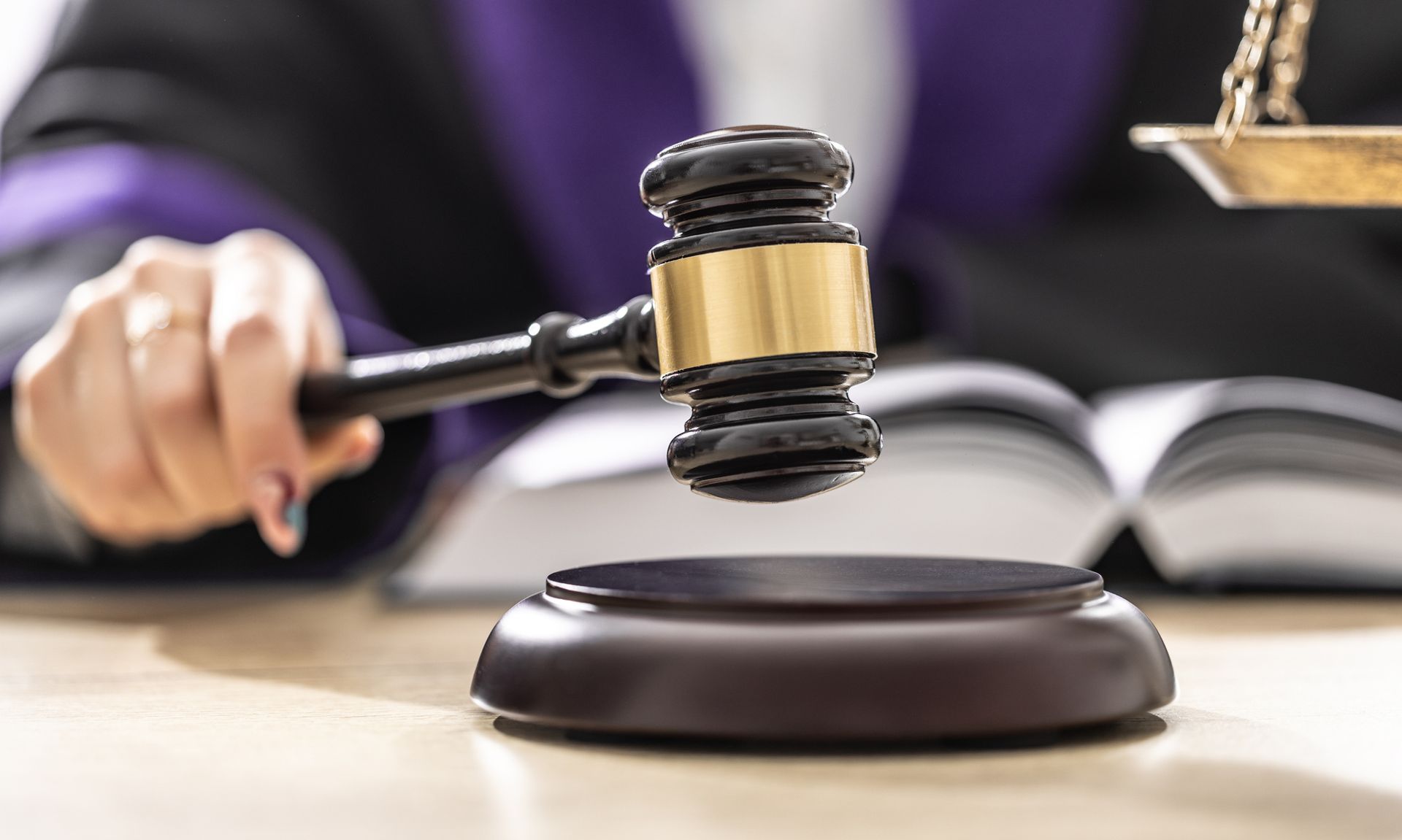 Judge is Holding a Gavel in Front of an Open Book — Eau Claire, WI — Cohen Law Offices Judge is Holding a Gavel in Front of an Open Book — Eau Claire, WI — Cohen Law Offices