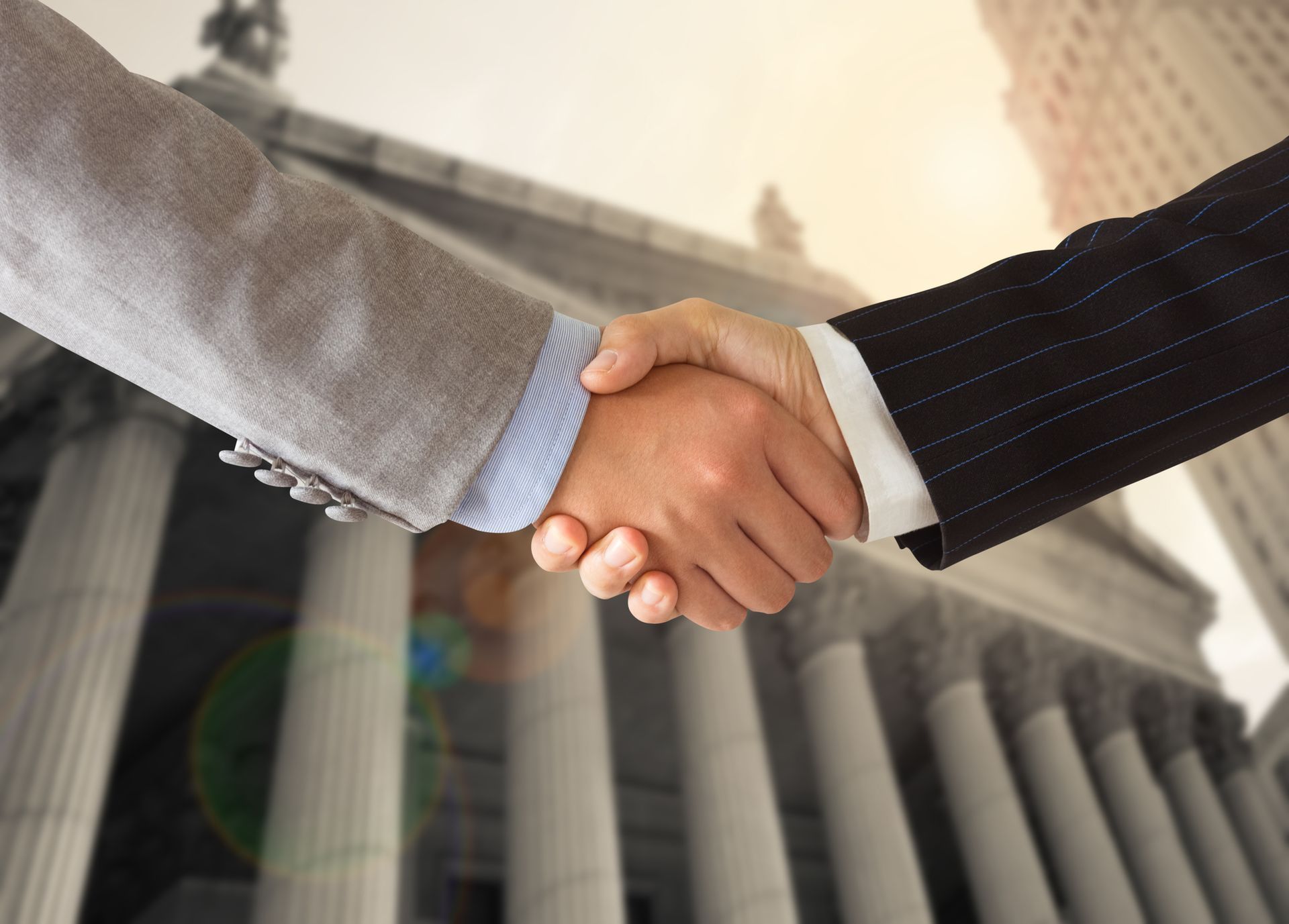 Lawyer and client shaking hands showcasing trusted defense in violent crimes cases representation. Lawyer and client shaking hands showcasing trusted defense in violent crimes cases representation.