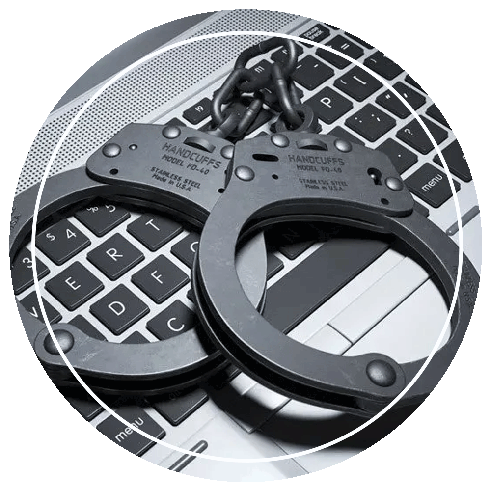 Handcuffs on Laptop Keyboard — Eau Claire, WI — Cohen Law Offices Handcuffs on Laptop Keyboard — Eau Claire, WI — Cohen Law Offices