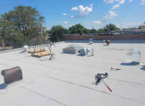 A white roof with a few tools on it