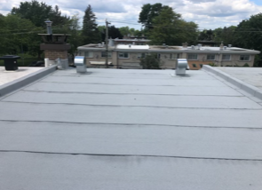 A gray roof with a chimney on top of it